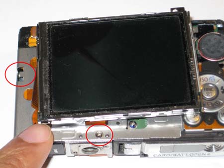 The clip holding the LCD in place and the screw holding the tripod mount